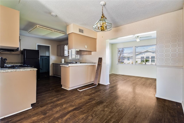 kitchen with visible vents, dark wood-type flooring, light countertops, and freestanding refrigerator