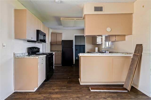 kitchen with dark wood finished floors, black appliances, a peninsula, and visible vents