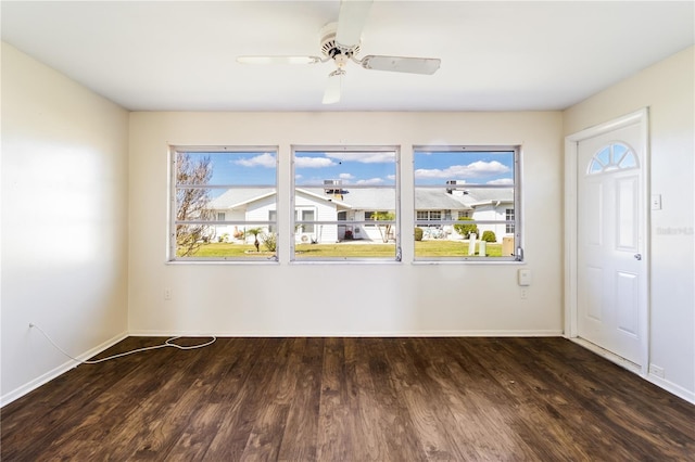 spare room with ceiling fan, baseboards, and wood finished floors