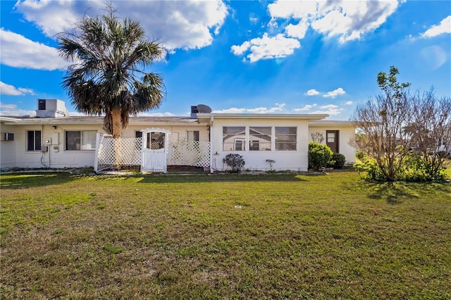 ranch-style home with a front yard and central AC unit