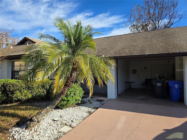 view of exterior entry featuring a carport