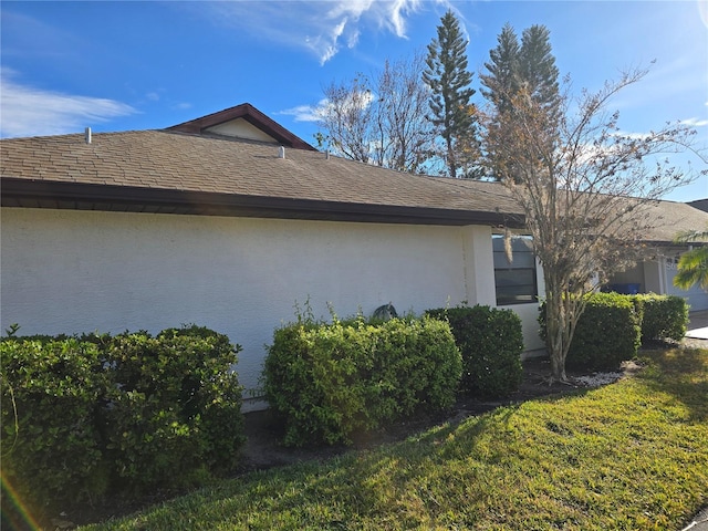 view of side of property with a lawn