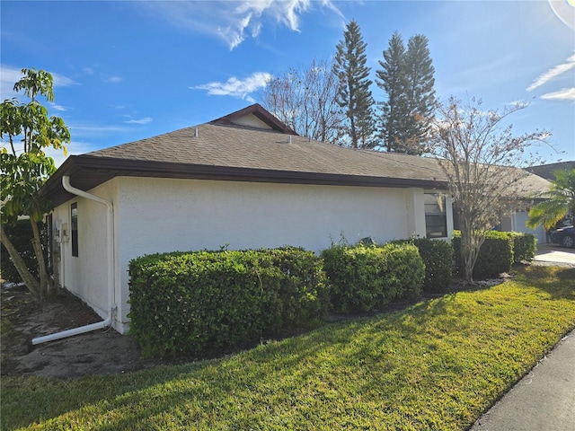 view of side of home with a yard