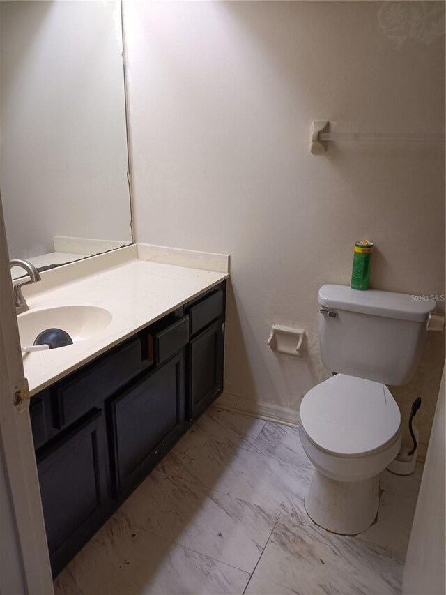 bathroom featuring vanity and toilet