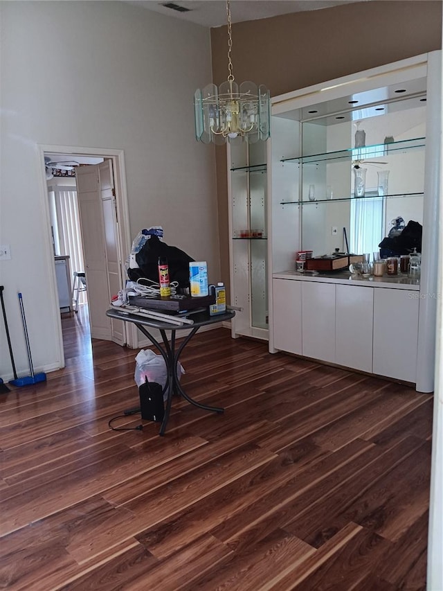 dining area featuring dark hardwood / wood-style floors and a notable chandelier