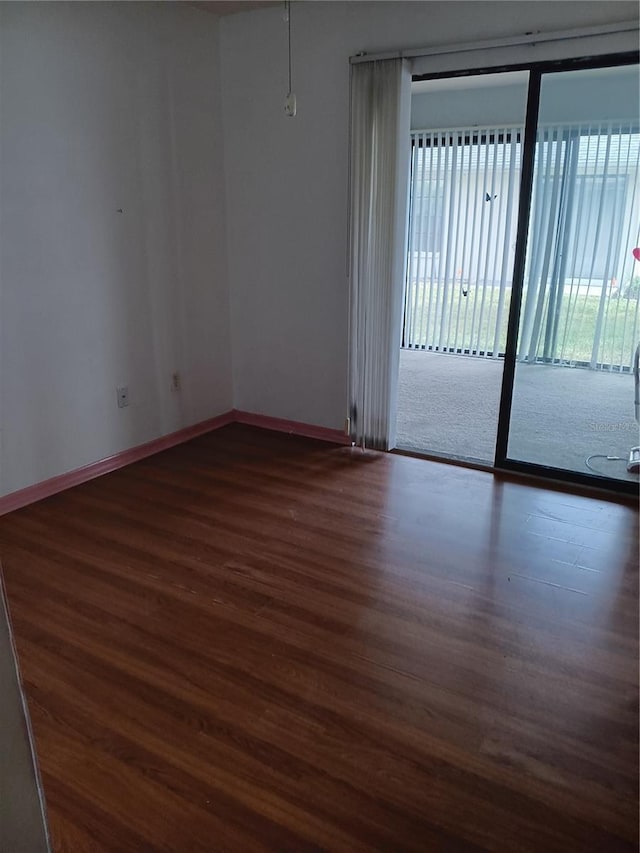 spare room featuring dark hardwood / wood-style floors