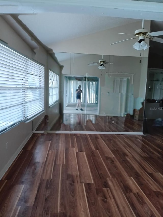 interior space featuring dark wood-type flooring, vaulted ceiling, and ceiling fan