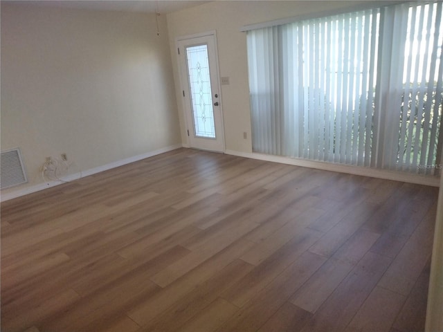 unfurnished room featuring hardwood / wood-style flooring