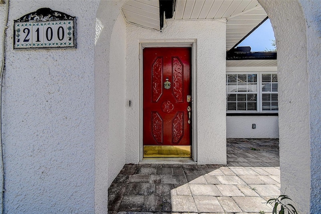 doorway to property with stucco siding