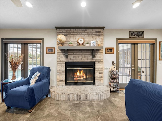 living room featuring french doors and a fireplace