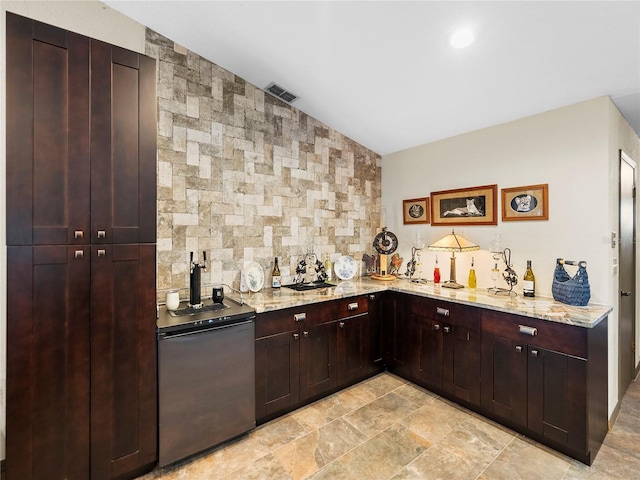 bar with light stone countertops, stainless steel fridge, and lofted ceiling