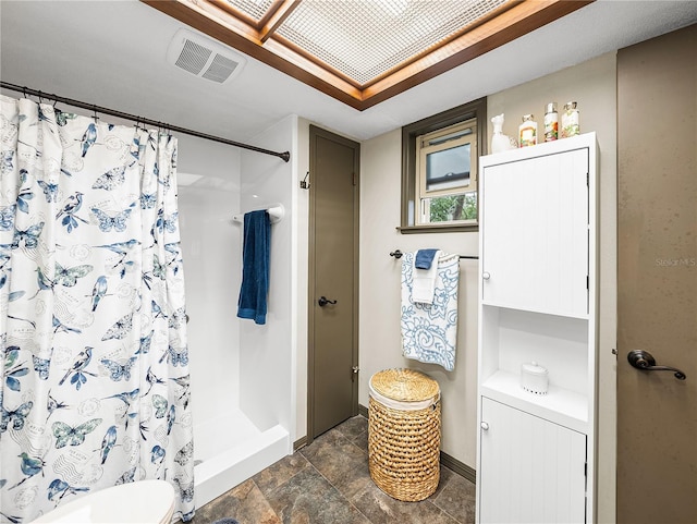 bathroom featuring curtained shower and toilet