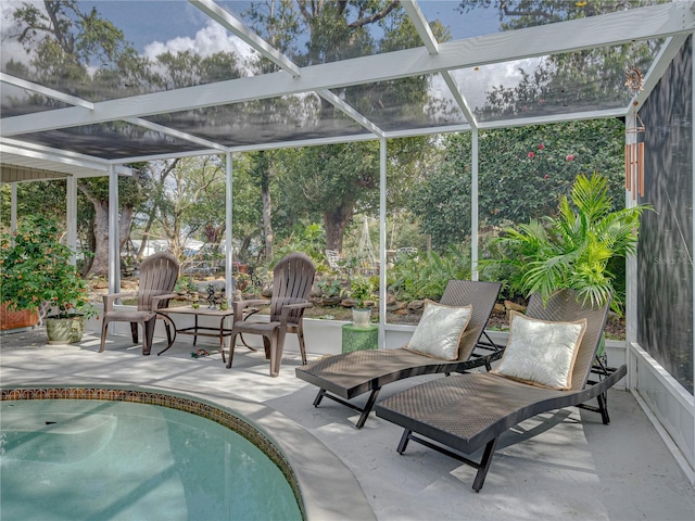 view of swimming pool with a patio and a lanai