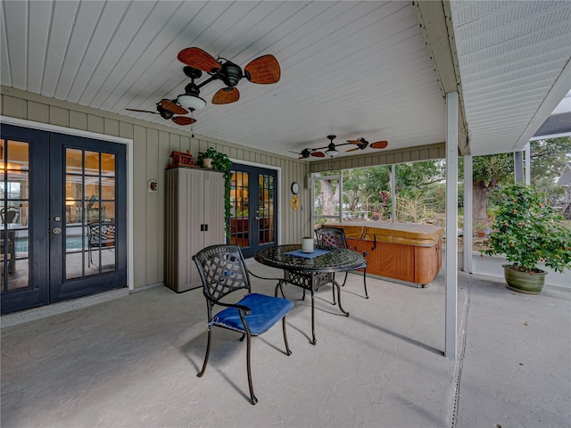 view of patio / terrace featuring ceiling fan, a hot tub, and french doors