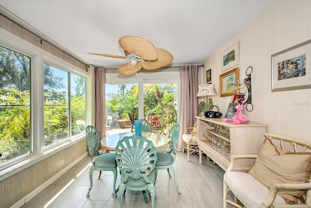 sunroom featuring ceiling fan