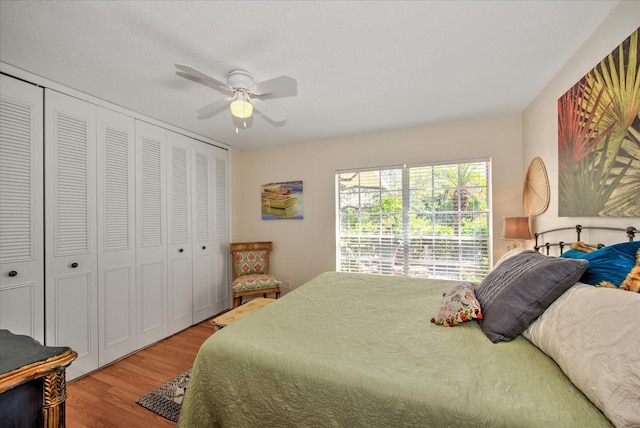 bedroom with a closet, hardwood / wood-style floors, and ceiling fan