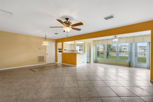 unfurnished living room featuring ceiling fan, visible vents, baseboards, and light tile patterned flooring