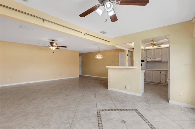 unfurnished room with light tile patterned floors, visible vents, and baseboards