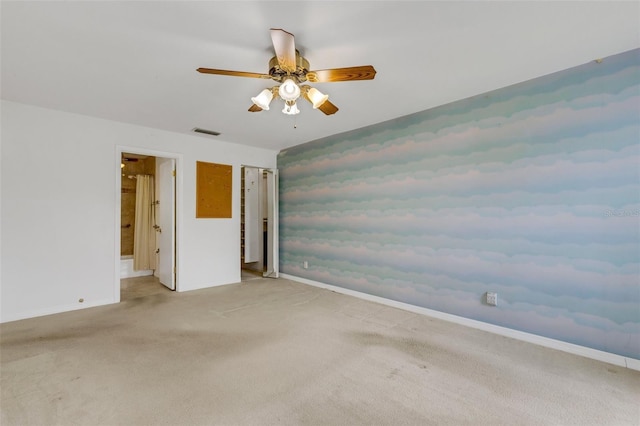 empty room featuring visible vents, ceiling fan, light carpet, and baseboards