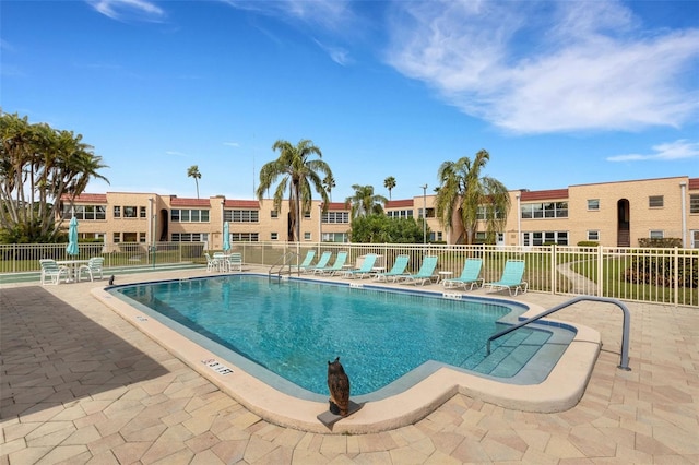 community pool featuring a patio and fence