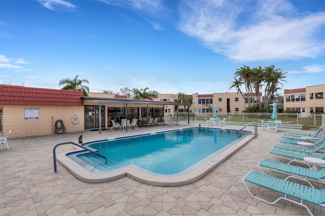 pool featuring a patio and fence