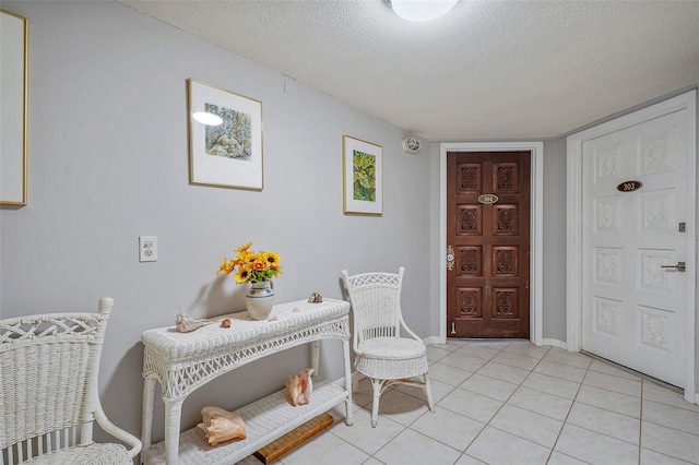 tiled foyer entrance featuring a textured ceiling