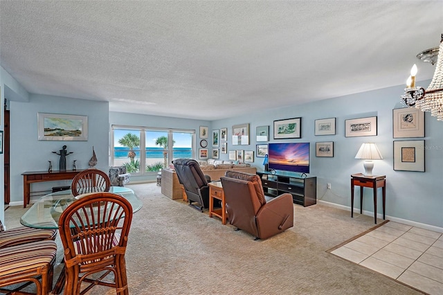 living room with light carpet, a textured ceiling, and a chandelier