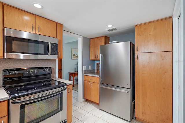 kitchen featuring light tile patterned flooring and appliances with stainless steel finishes