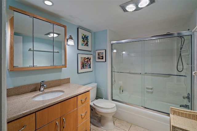 full bathroom featuring tile patterned flooring, vanity, bath / shower combo with glass door, and toilet