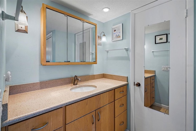 bathroom featuring vanity and a textured ceiling