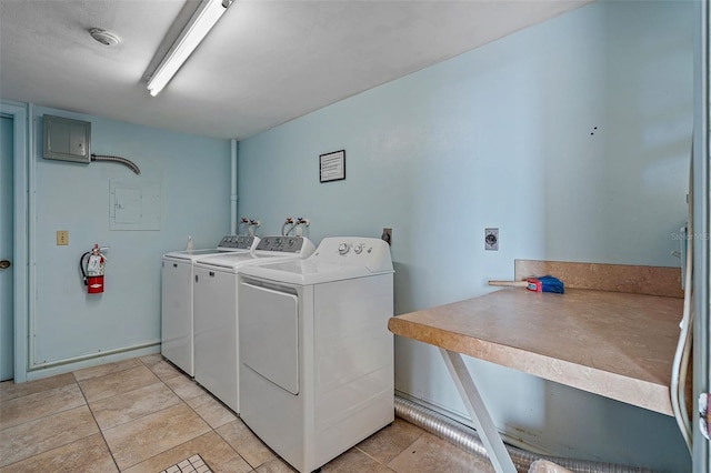 washroom featuring washer and clothes dryer and light tile patterned flooring