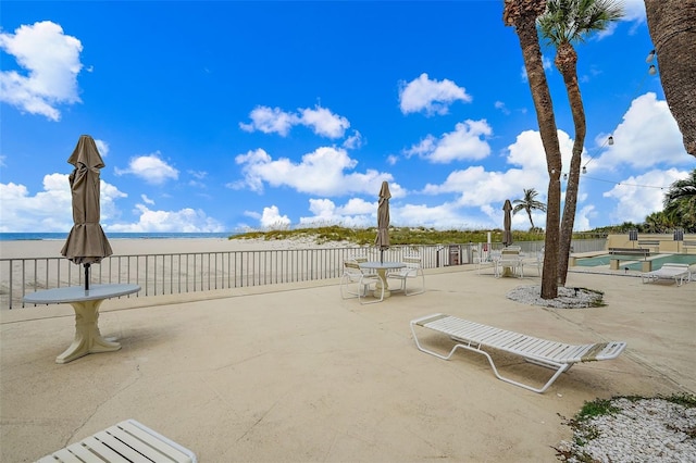 view of patio / terrace featuring a water view and a community pool