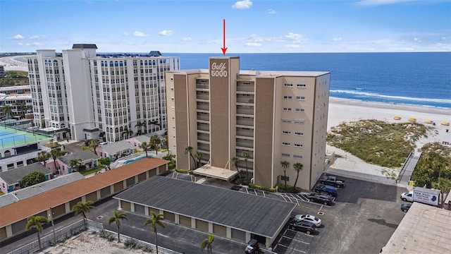 view of property with a water view and a view of the beach