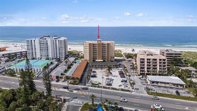 drone / aerial view featuring a water view and a view of the beach