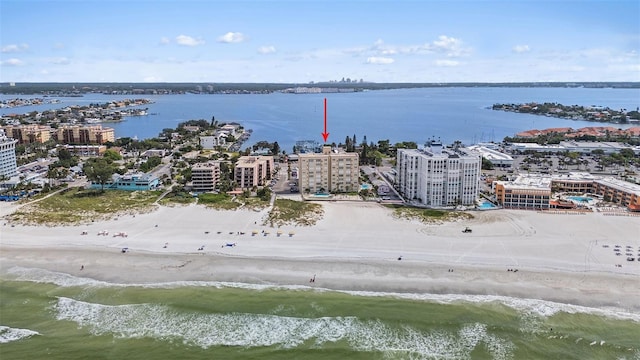 drone / aerial view featuring a beach view and a water view