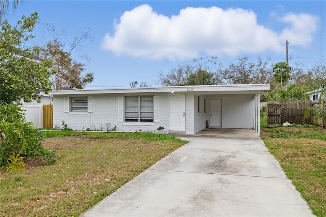 single story home featuring a front lawn and a carport