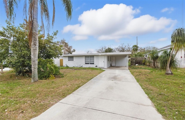 single story home with a front yard and a carport