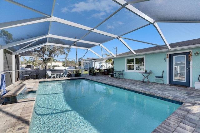 pool featuring glass enclosure and a patio