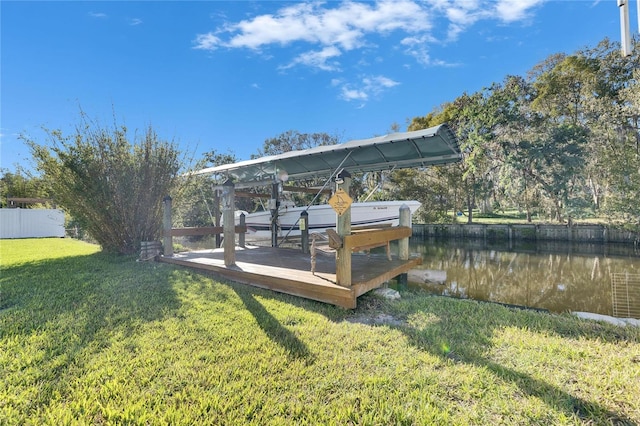 view of dock with a lawn, a water view, and fence