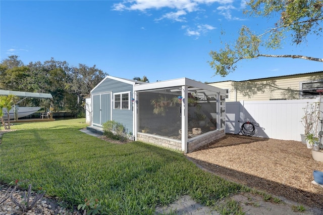 exterior space with fence and a yard