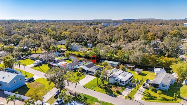 birds eye view of property featuring a residential view and a forest view