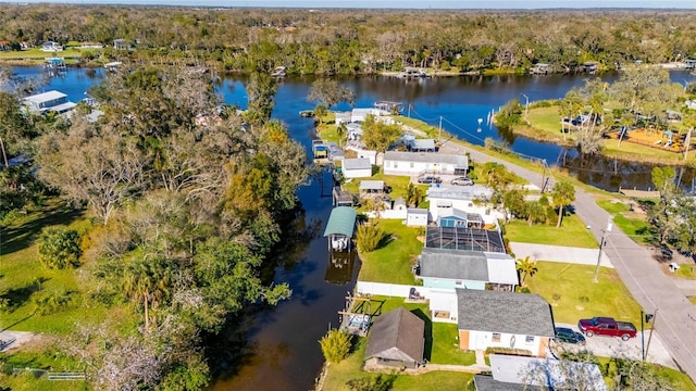 aerial view with a forest view and a water view