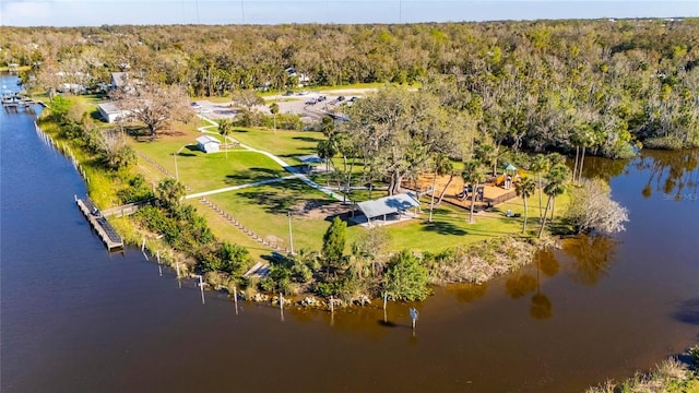 drone / aerial view with a water view and a wooded view