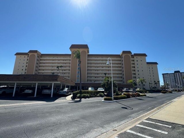 view of building exterior featuring covered parking