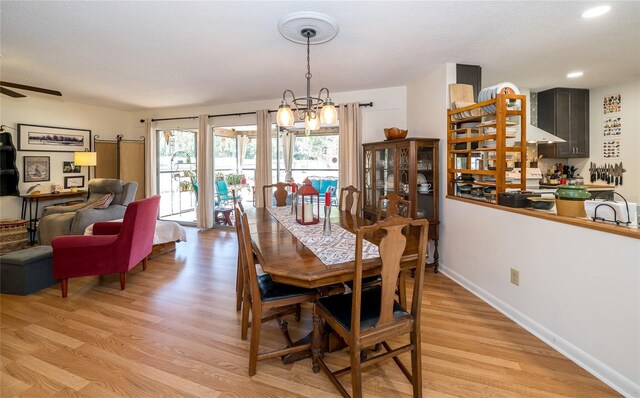 dining space featuring recessed lighting, light wood-type flooring, baseboards, and ceiling fan with notable chandelier