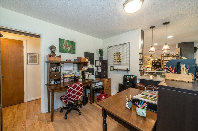 home office with a textured ceiling and wood finished floors