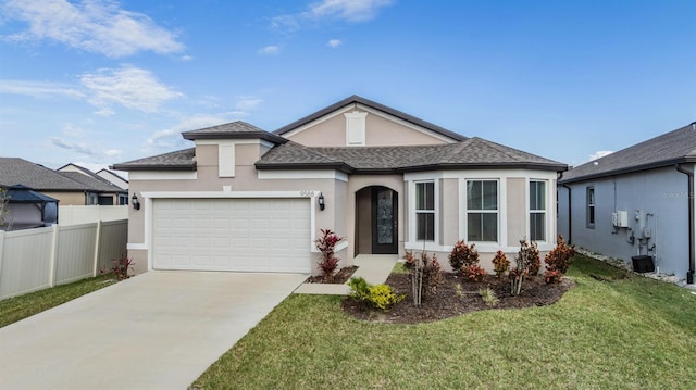 view of front of property with a front yard and a garage