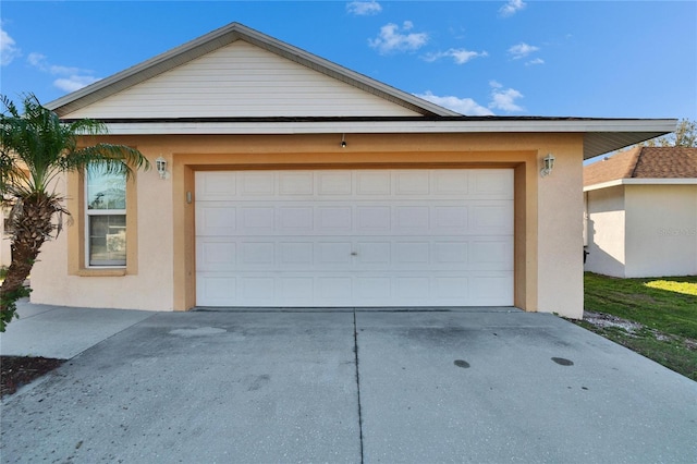 garage with concrete driveway