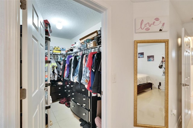 spacious closet with light tile patterned floors