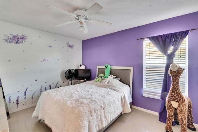 bedroom featuring a ceiling fan, light tile patterned flooring, and baseboards